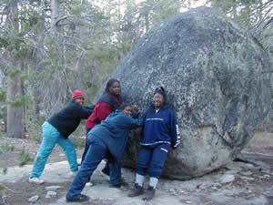 girls pushing rock